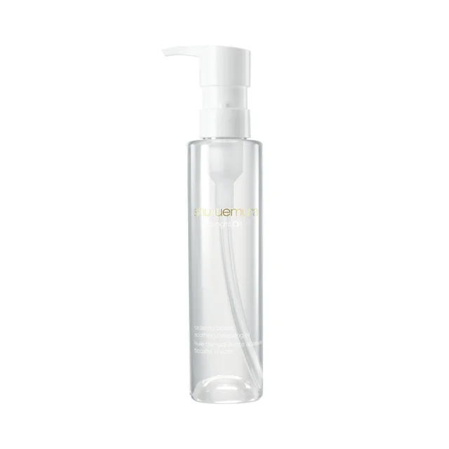 A clear, cylindrical plastic bottle of Shu Uemura Bright Oil cleansing oil stands upright against a plain white background, featuring a white pump dispenser at the top.